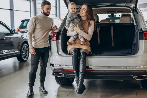 family-with-toddler-girl-choosing-car-car-showroom